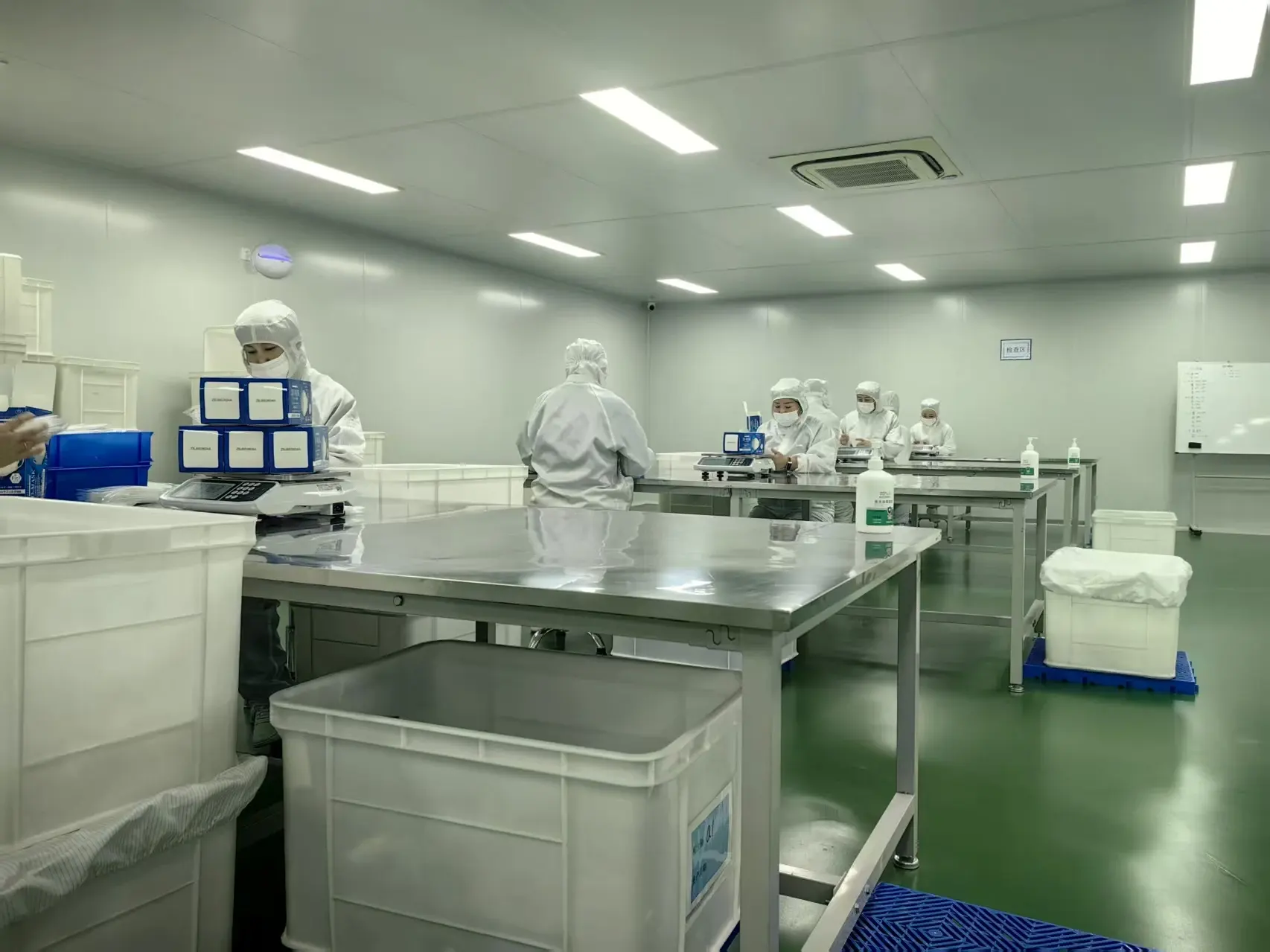Quality-control staff conducting manual random sampling before packaging