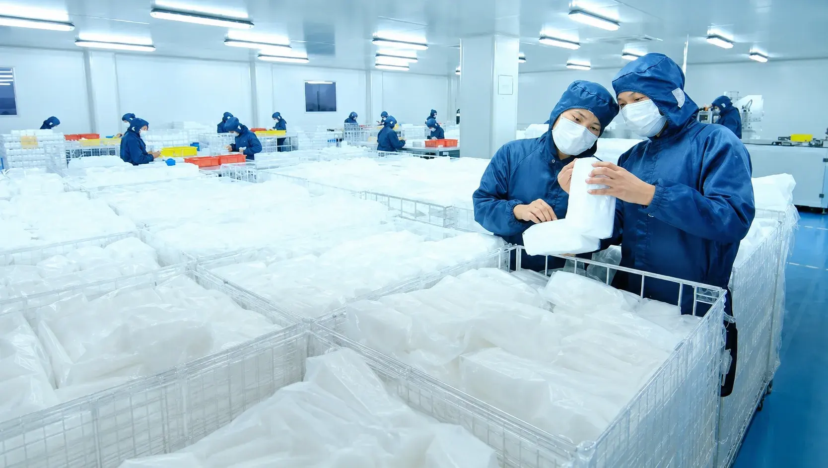 Production team inspecting finished wipe packs in a cleanroom