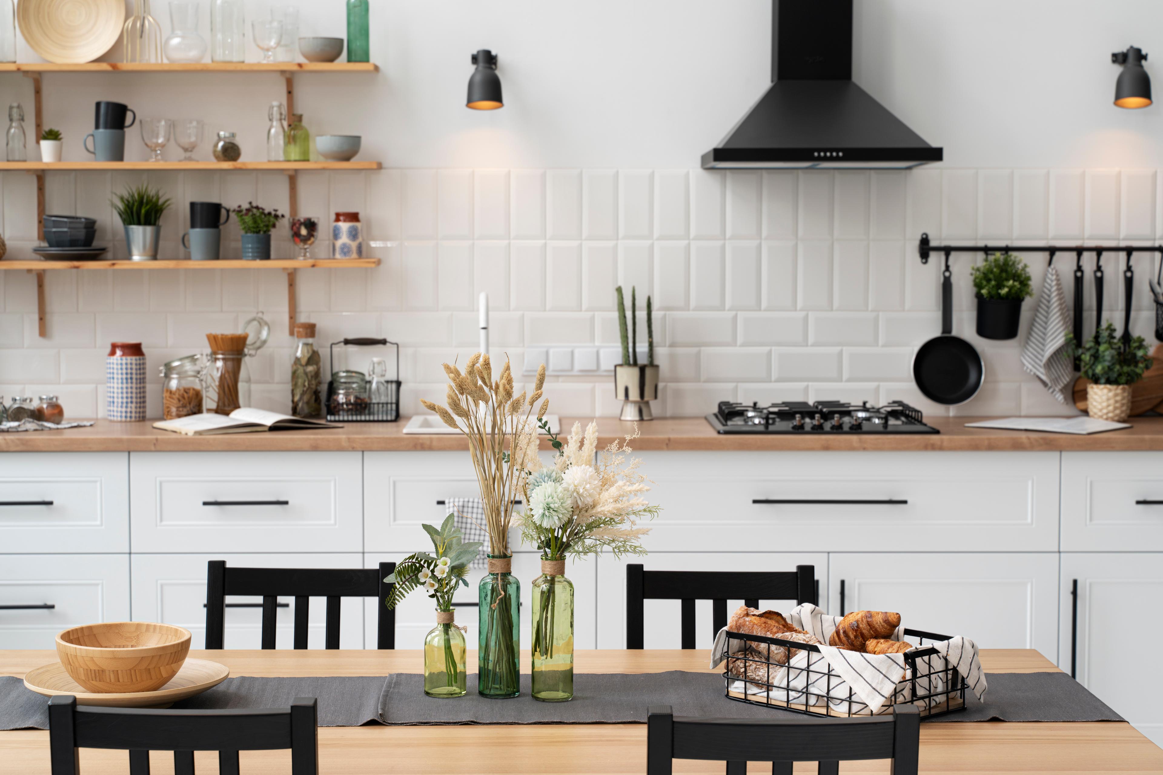 Kitchen worktop with cookware, utensils, storage jars and a stove
